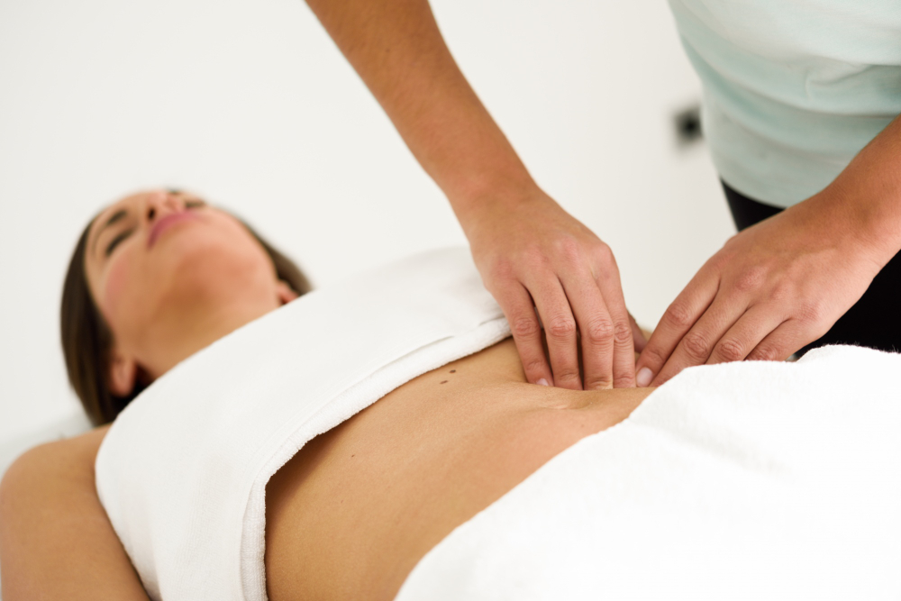 hands-massaging-female-abdomen-therapist-applying-pressure-belly.jpg